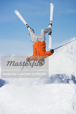 Skier jumping upside-down