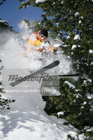 Skier jumping through trees