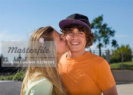 Teen girl kissing teen boy