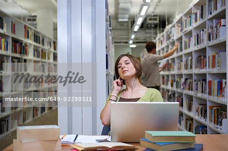 Young woman seated in library