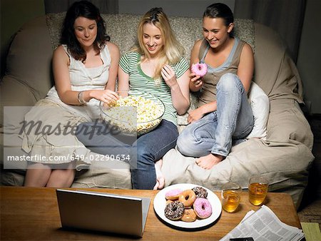 Three young women watching movie