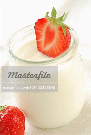 strawberry on pot of plain yoghurt