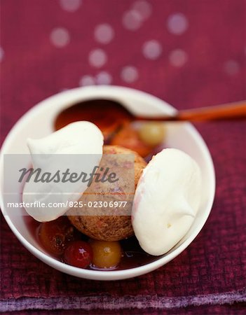 Cinnamon ice cream with meringue and fruits in syrup