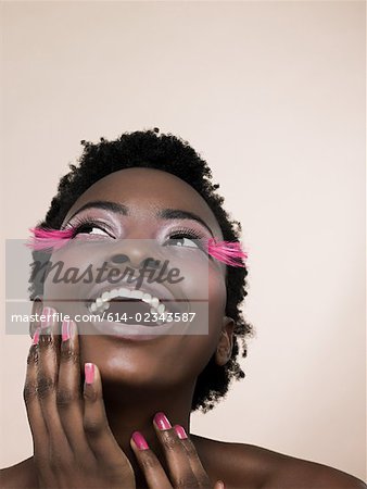 A woman wearing pink false eyelashes
