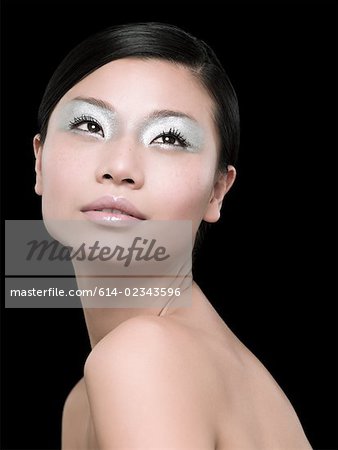 A young woman wearing silver eyeshadow