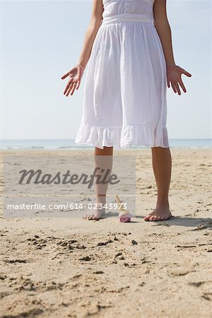 Woman dropping her ice cream on beach