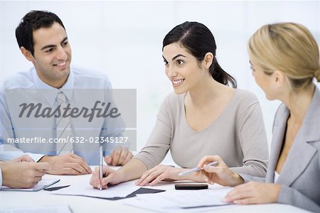 Businessman sitting with colleagues at conference table