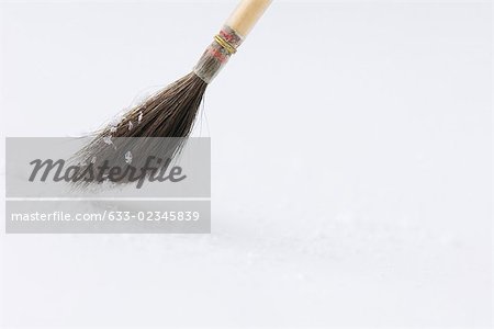 Paintbrush stroking snow, close-up