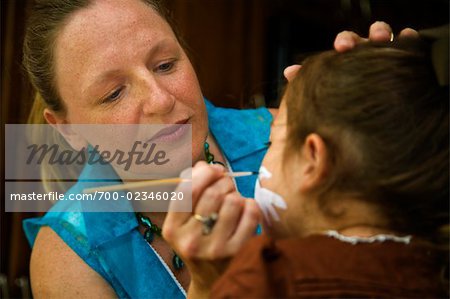 Woman Painting Girl's Face