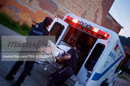 Police Officer and Paramedics Loading Body into Ambulance, Toronto, Ontario, Canada