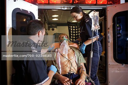 Paramedics loading Injured Man into Ambulance, Toronto, Ontario, Canada