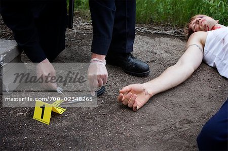 Police Officer's Hands with Evidence and Corpse on Crime Scene, Toronto, Ontario, Canada