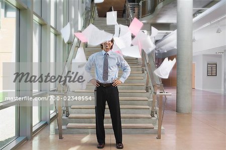 Businessman Throwing Papers Up in the Air