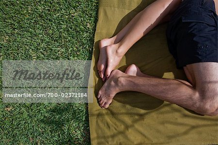 Couple Lying on Towel on the Grass