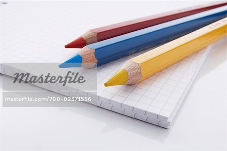 Close-up of Pencil Crayons and Graph Paper