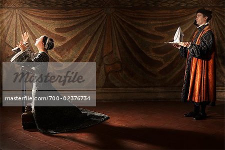 Medieval Servant Presenting Iron to Praying Woman