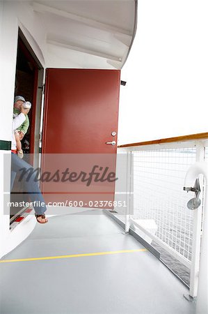 Woman Stepping Onto Ship Deck Holding Baby