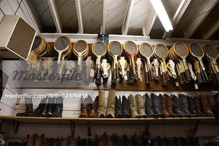 Row of Tennis Racquets and Cowboy Boots