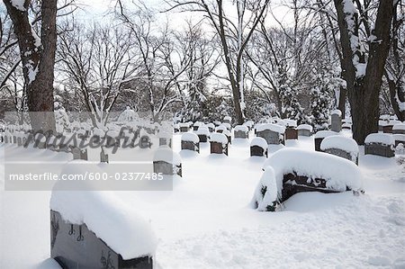 Headstones in Cemetery Covered in Fresh Snow, Toronto, Ontario, Canada