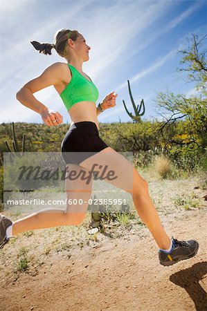 Woman Running on Desert Trail, Saguaro National Park, Tucson, Arizona, USA