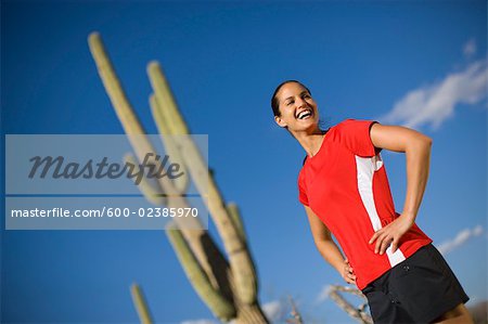 Woman Standing in Front of a Saguaro Cactus, Tucson, Arizona, USA