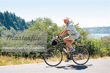 Man riding a bicycle on a road, Washington State, USA
