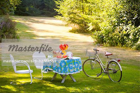 Breakfast table and a bicycle in a garden