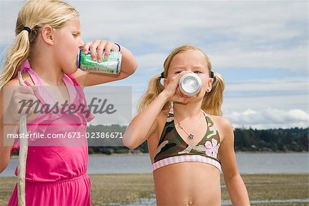 Two girls drinking soda