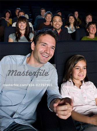 A father and daughter watching a movie