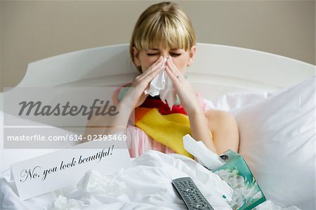 A woman in bed with a cold