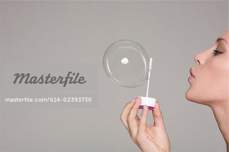 Young woman blowing a bubble