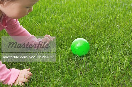 Toddler baby playing with ball