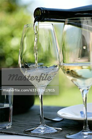 White wine being poured into wine glasses