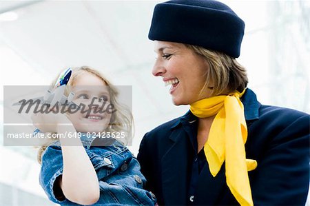 Stewardess holding child in her arms