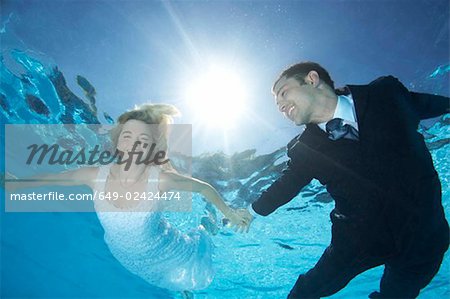 Bride and groom underwater