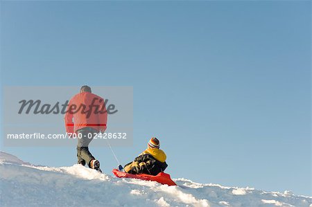 Father and Child Tobogganing, Salzburger Land, Austria