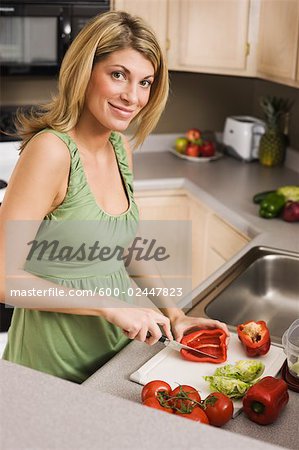 Woman in Kitchen Making a Salad