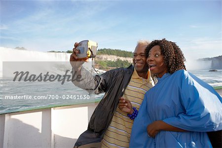 Couple Taking a Picture of Themselves Aboard The Maid of the Mist, Niagara Falls, Ontario, Canada