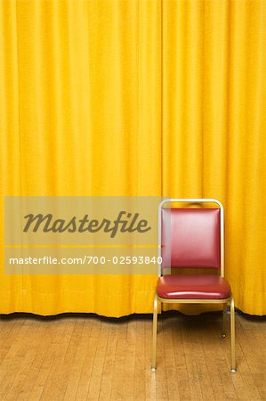 Stool on Stage with Yellow Curtains
