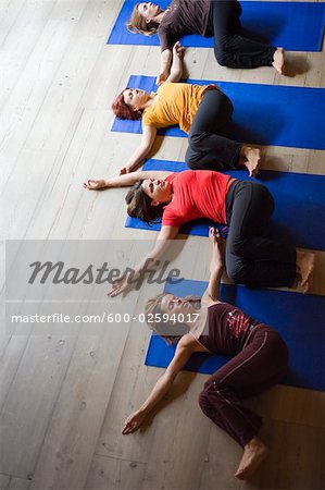 Women in Yoga Class Doing Spinal Twist