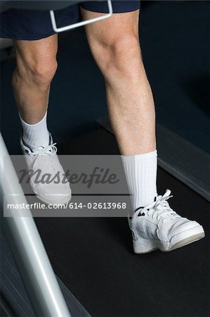 Mature man walking on a treadmill