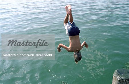 Boy jumping headlong into Water - Swimming - Leisure Time - Youth