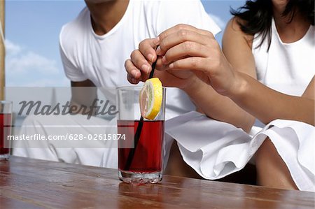Couple sitting at tables with drinks