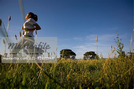 Teenager girl jogging in countryside