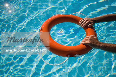 Man holding life ring floating in water