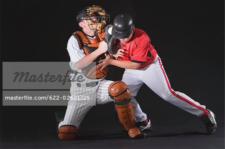 Baseball player sliding into a base