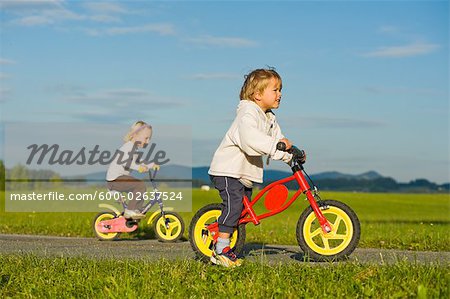 Boy and Girl Riding Bicycles,  Hof bei Salzburg, Salzburger Land, Austria