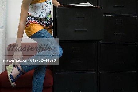 Femme chaussure, s'appuyant sur le classeur de réglage