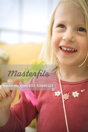 Little girl playing with clapping toy, laughing