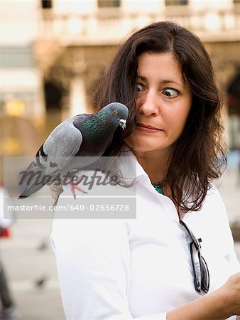 Woman with birds on her shoulder.